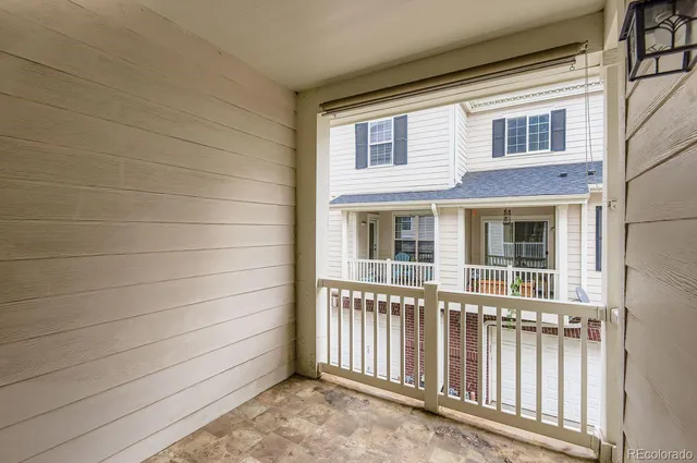 a view of a house with a small yard and wooden floor
