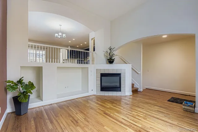 a view of empty room with wooden floor and a potted plant