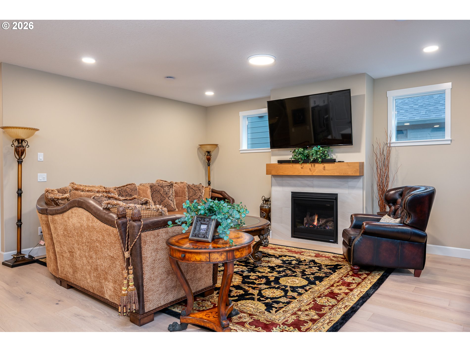 Undisclosed Address Ridgefield, WA 98642 - Photo 16 of 46 a living room with furniture a flat screen tv and a fireplace
