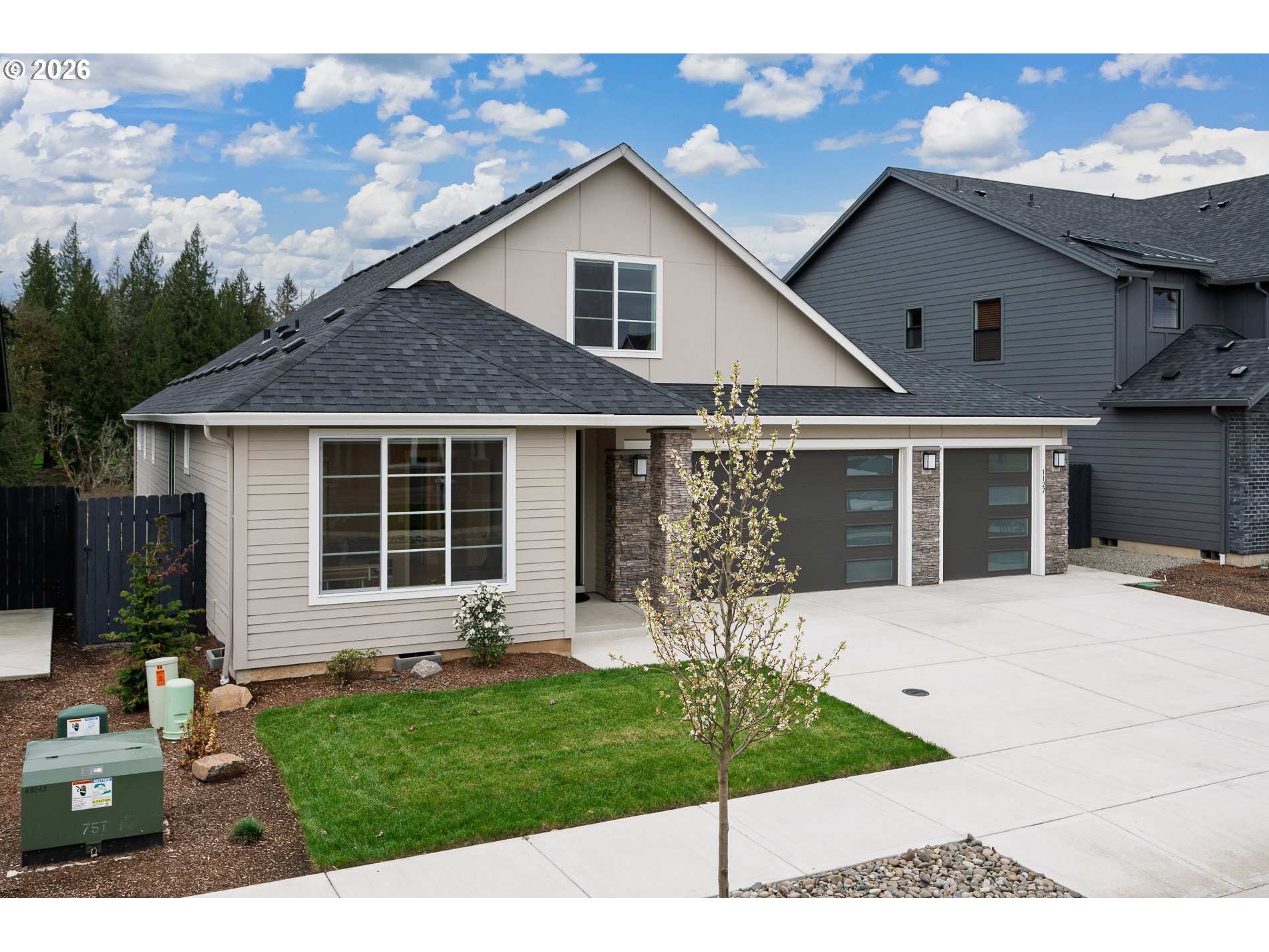 Undisclosed Address Ridgefield, WA 98642 - Photo 2 of 46 a front view of a house with a yard and potted plants