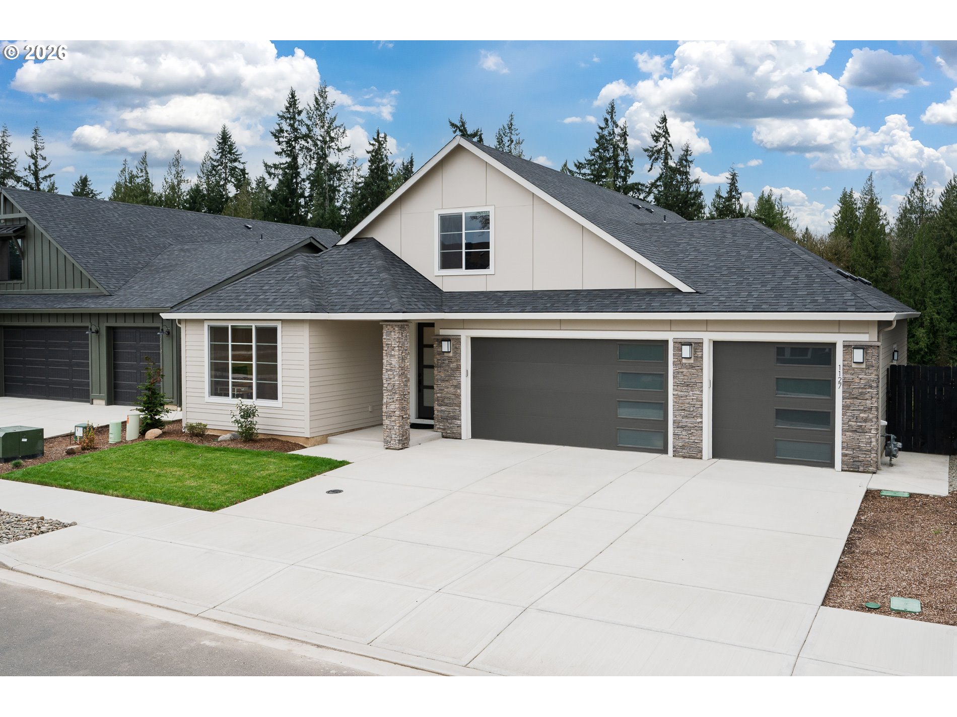 Undisclosed Address Ridgefield, WA 98642 - Photo 3 of 46 a front view of a house with a yard and garage