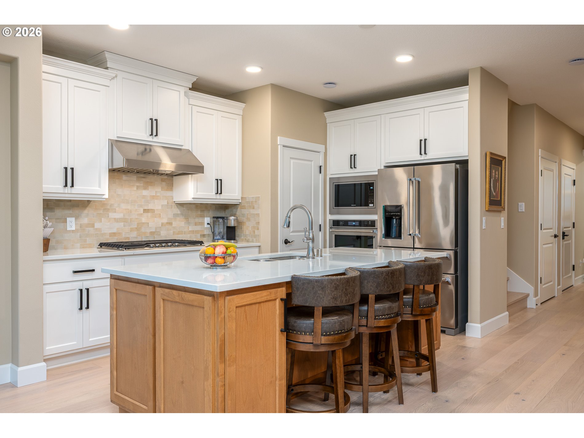 Undisclosed Address Ridgefield, WA 98642 - Photo 8 of 46 a kitchen with stainless steel appliances granite countertop a table chairs refrigerator and microwave