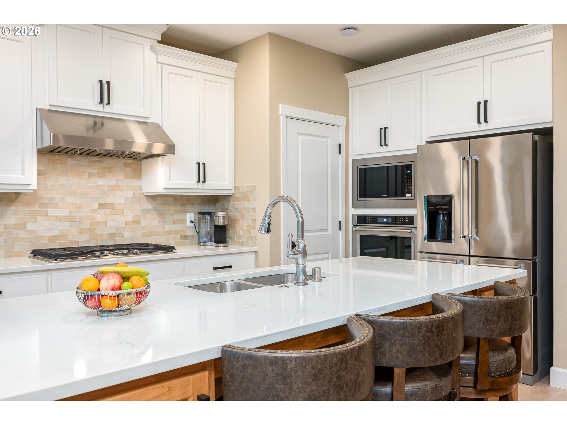 Undisclosed Address Ridgefield, WA 98642 - Photo 10 of 46 a kitchen with kitchen island granite countertop a sink a stove and refrigerator