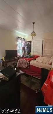 a bedroom with a bed and a chandelier