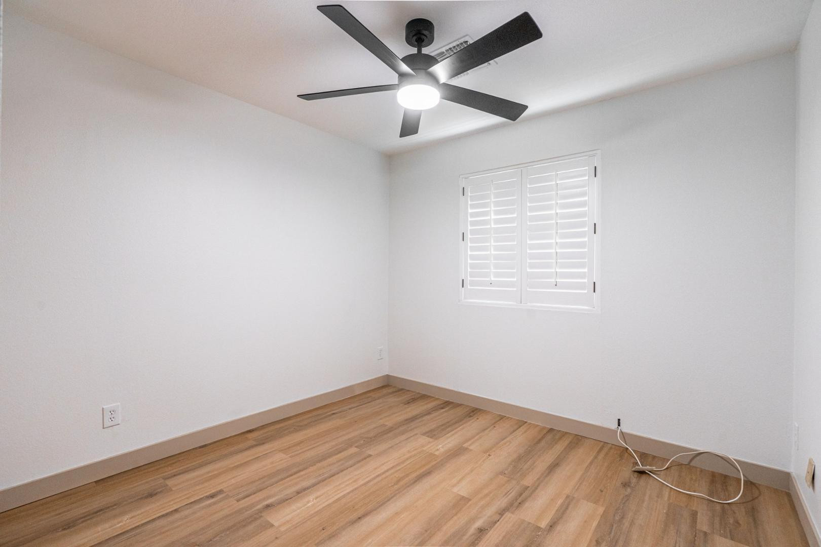 5739 West Monte Vista Road Phoenix, AZ 85035 - Photo 13 of 23 an empty room with a window and a ceiling fan