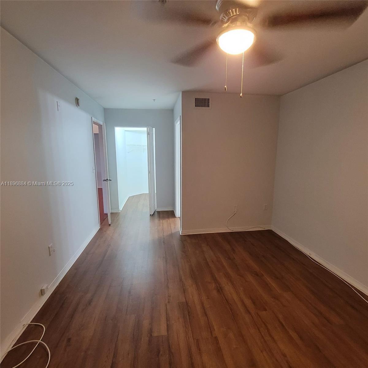 711 Southwest 111th Way, Unit 301 Pembroke Pines, FL 33025 - Photo 14 of 20 a view of wooden floor and a chandelier in a room