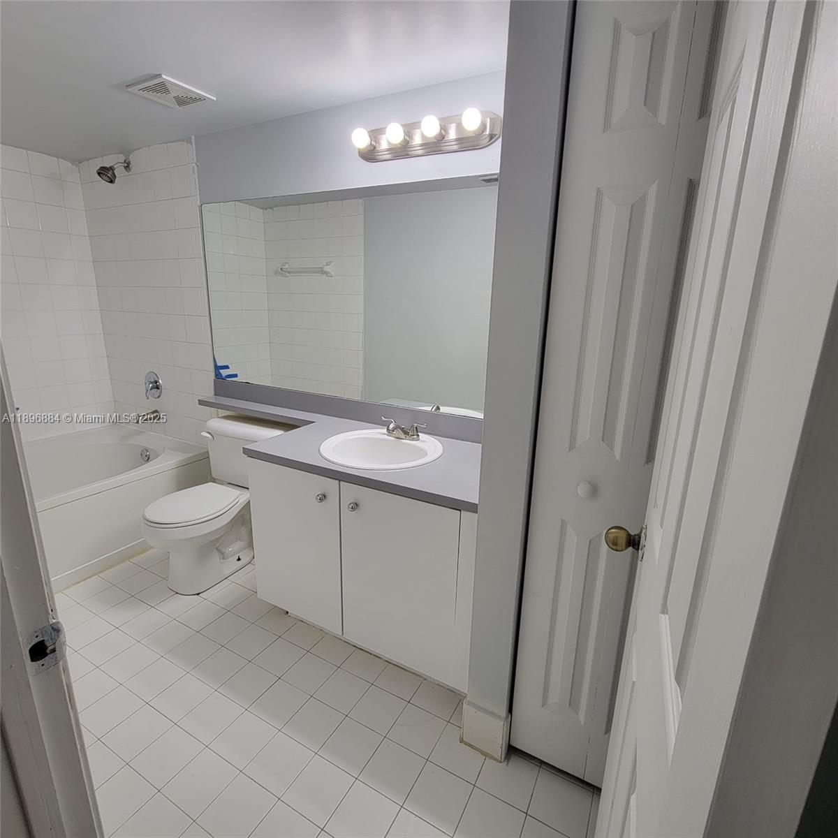 711 Southwest 111th Way, Unit 301 Pembroke Pines, FL 33025 - Photo 17 of 20 a bathroom with a granite countertop sink toilet and shower