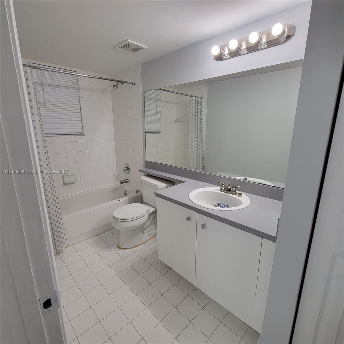 711 Southwest 111th Way, Unit 301 Pembroke Pines, FL 33025 - Photo 18 of 20 a bathroom with a sink a toilet and shower