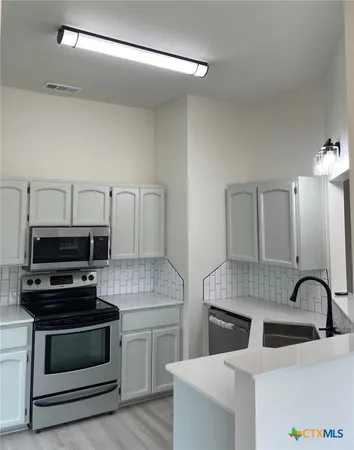 a kitchen with a stove and a microwave