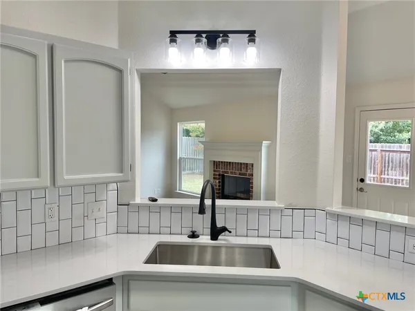 a kitchen with a sink and a window