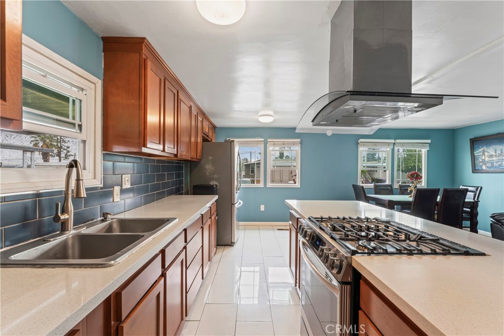 63 Round Table Drive Riverside, CA 92507 - Photo 1 of 1 a kitchen with stainless steel appliances granite countertop a sink stove and refrigerator