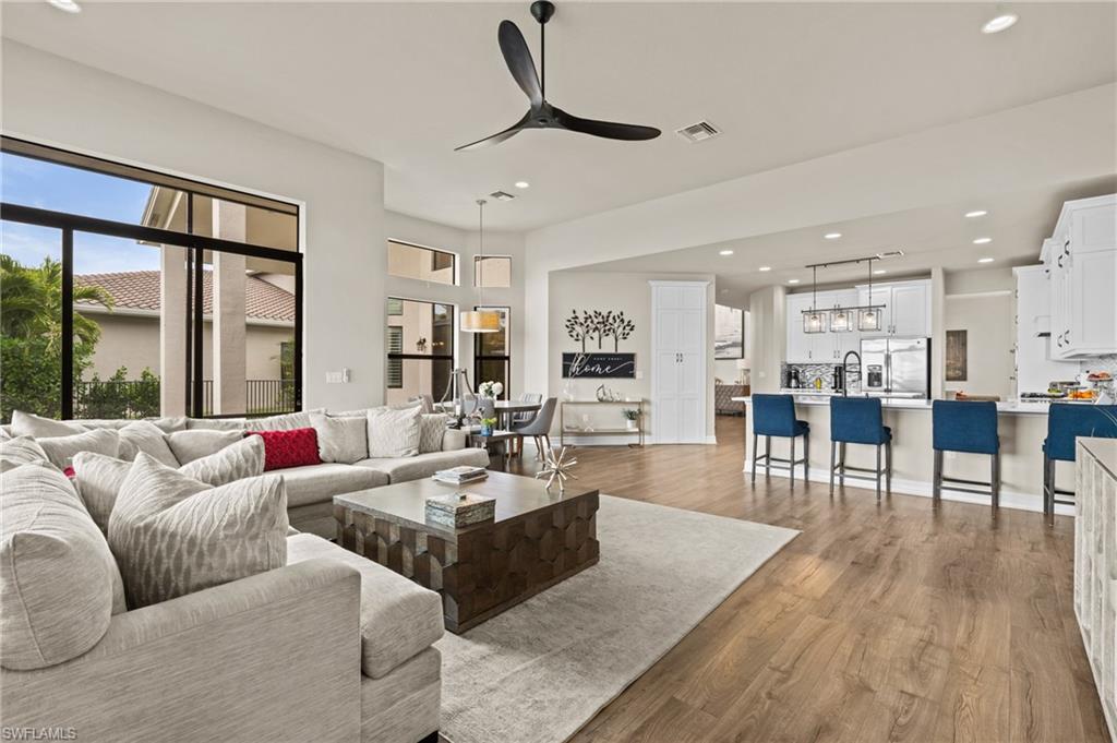 4644 Azalea Drive Naples, FL 34119 - Photo 13 of 48 a living room with furniture wooden floor and a table