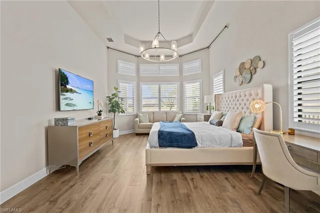 a living room with furniture large window and wooden floor
