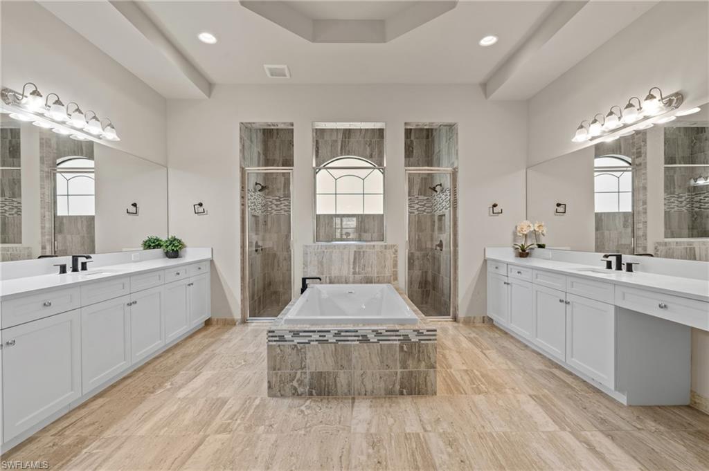 4644 Azalea Drive Naples, FL 34119 - Photo 17 of 48 a large bathroom with a double vanity sink and a mirror