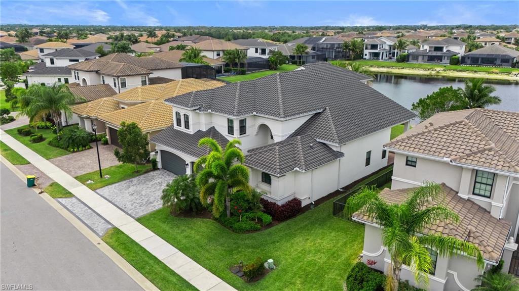 4644 Azalea Drive Naples, FL 34119 - Photo 2 of 48 an aerial view of a house with garden space and lake view