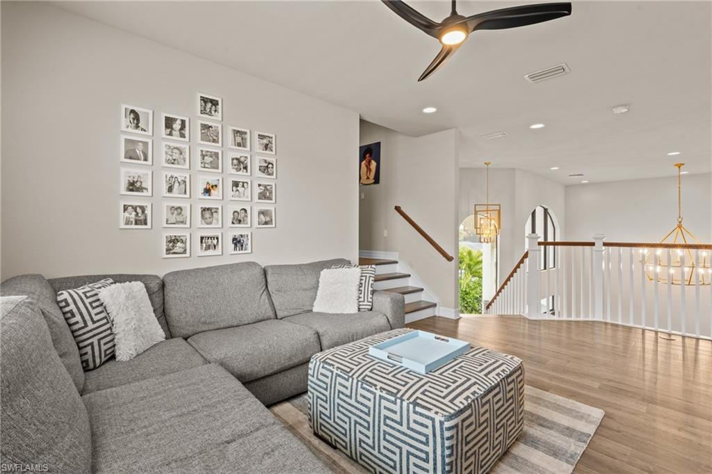 4644 Azalea Drive Naples, FL 34119 - Photo 23 of 48 a living room with furniture and wooden floor