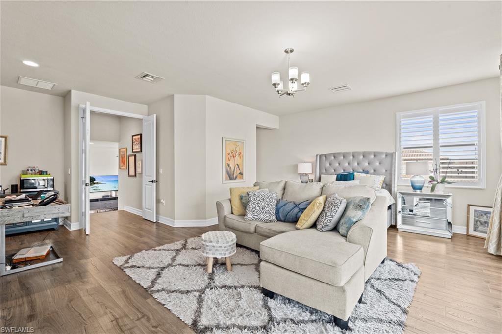 4644 Azalea Drive Naples, FL 34119 - Photo 25 of 48 a living room with furniture or couch and a wooden floor
