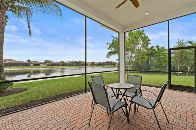 a view of a patio with a table chairs and a yard