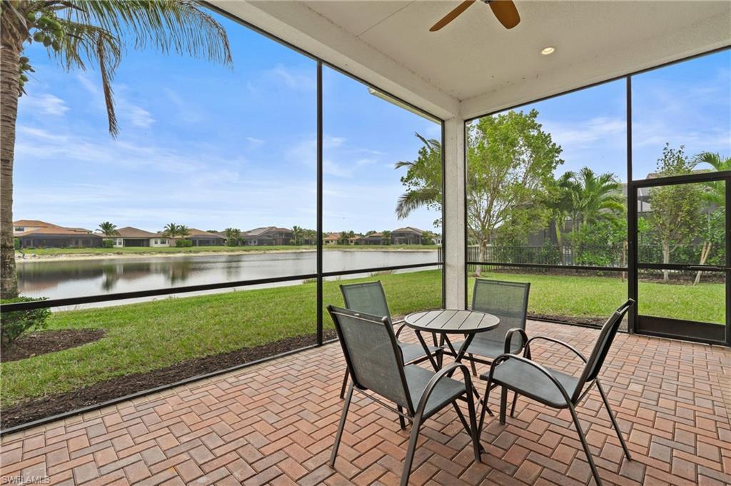4644 Azalea Drive Naples, FL 34119 - Photo 30 of 48 a view of a patio with a table chairs and a yard