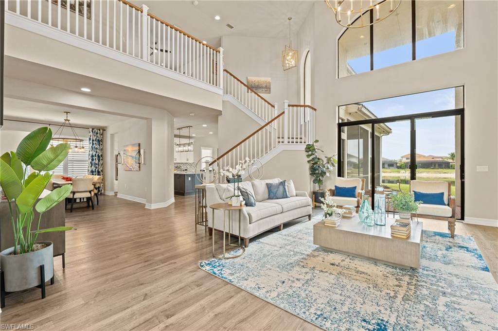 4644 Azalea Drive Naples, FL 34119 - Photo 3 of 48 a living room with furniture and a dining table with wooden floor