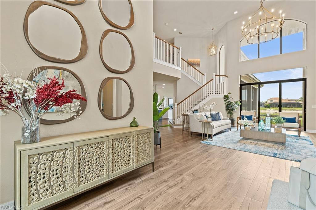 4644 Azalea Drive Naples, FL 34119 - Photo 4 of 48 a living room with furniture a fireplace and a table