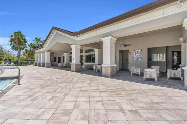a view of a house with backyard porch and sitting area