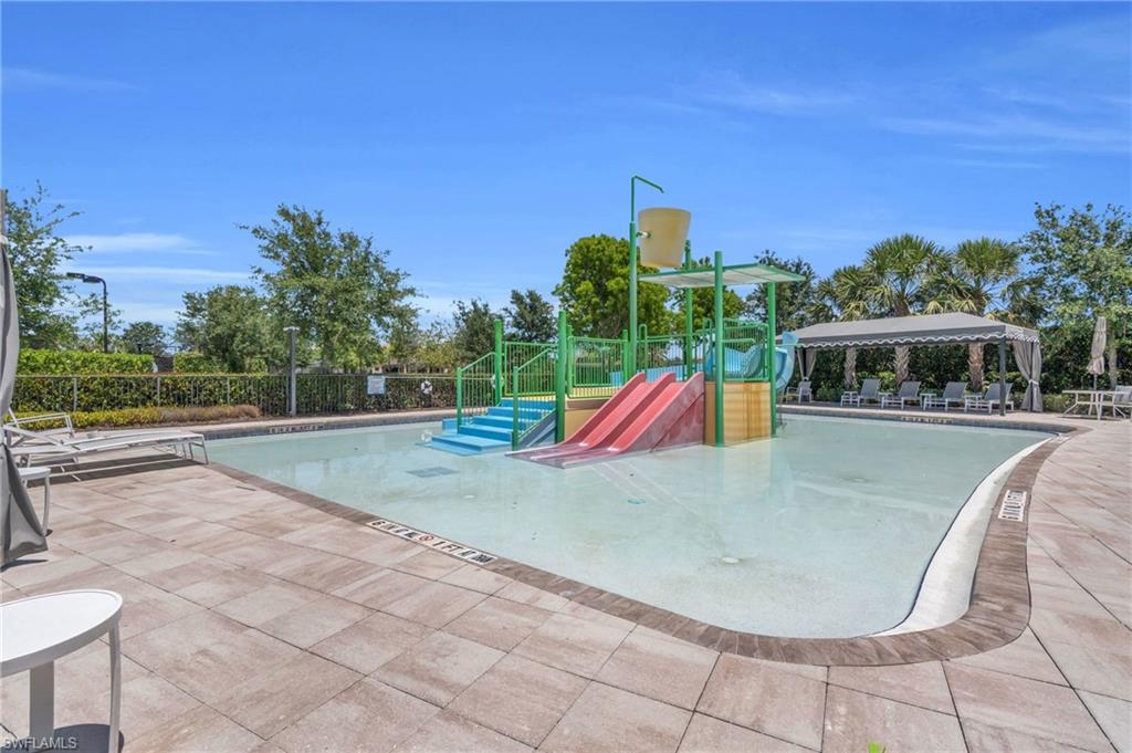 4644 Azalea Drive Naples, FL 34119 - Photo 44 of 48 a view of a swimming pool with a yard