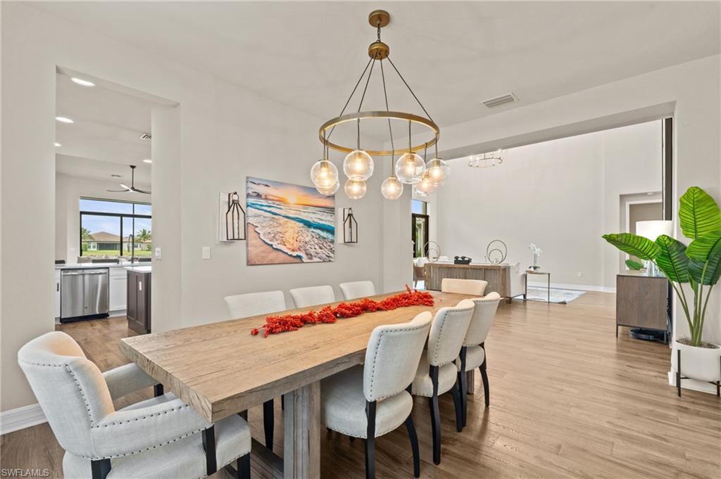 4644 Azalea Drive Naples, FL 34119 - Photo 6 of 48 a view of a dining room with furniture window and wooden floor