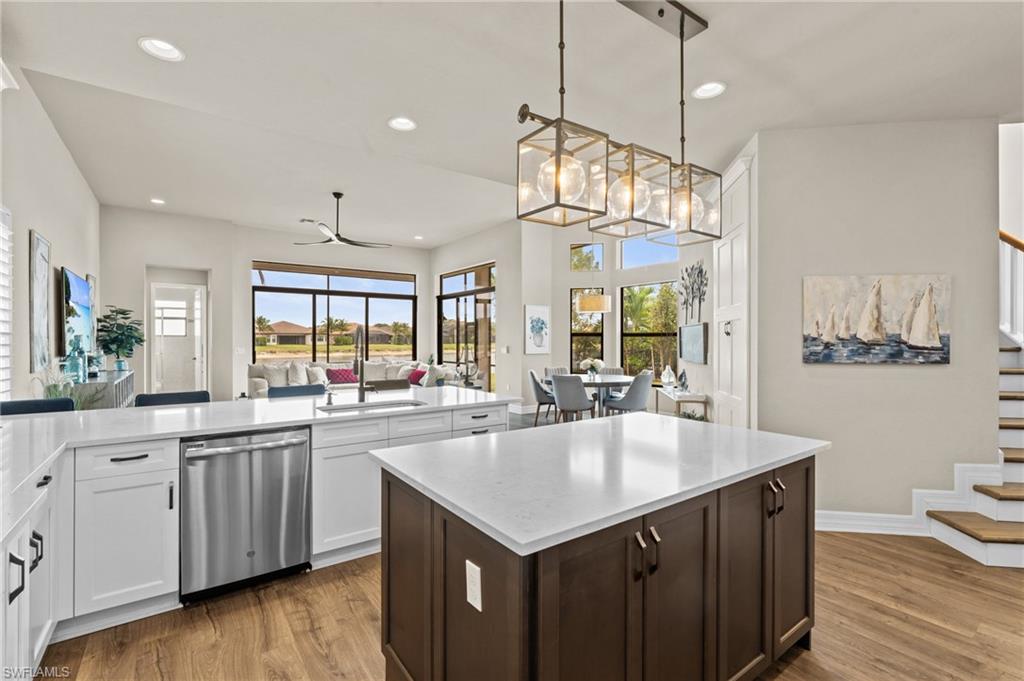 4644 Azalea Drive Naples, FL 34119 - Photo 8 of 48 a kitchen with a stove a sink dishwasher a kitchen island with wooden cabinets and wooden floor