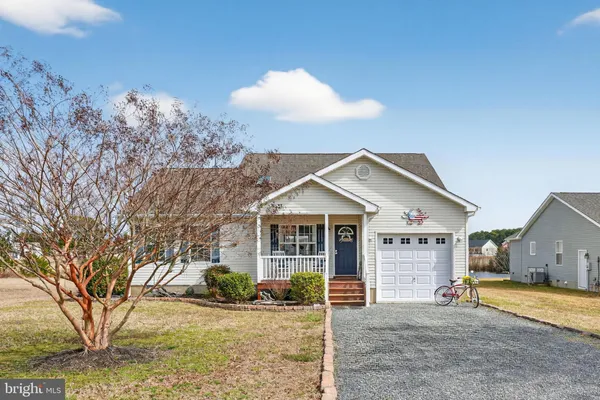 a view of a house with a patio and a yard