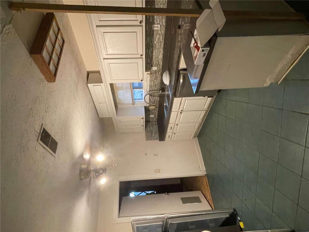 3409 Salem Road Covington, GA 30016 - Photo 13 of 16 a kitchen with a sink cabinets and stainless steel appliances