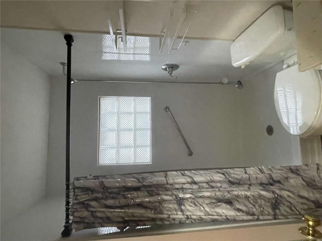 3409 Salem Road Covington, GA 30016 - Photo 10 of 16 a bathroom with a toilet and shower