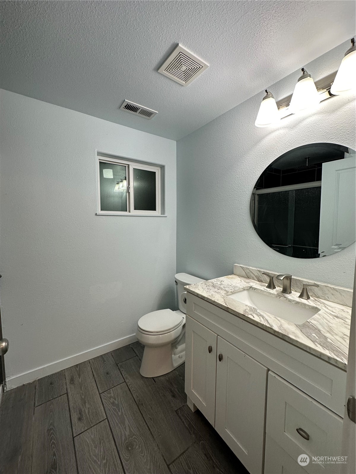 4520 Eels Road Cashmere, WA 98815 - Photo 11 of 17 a bathroom with a granite countertop toilet sink and mirror