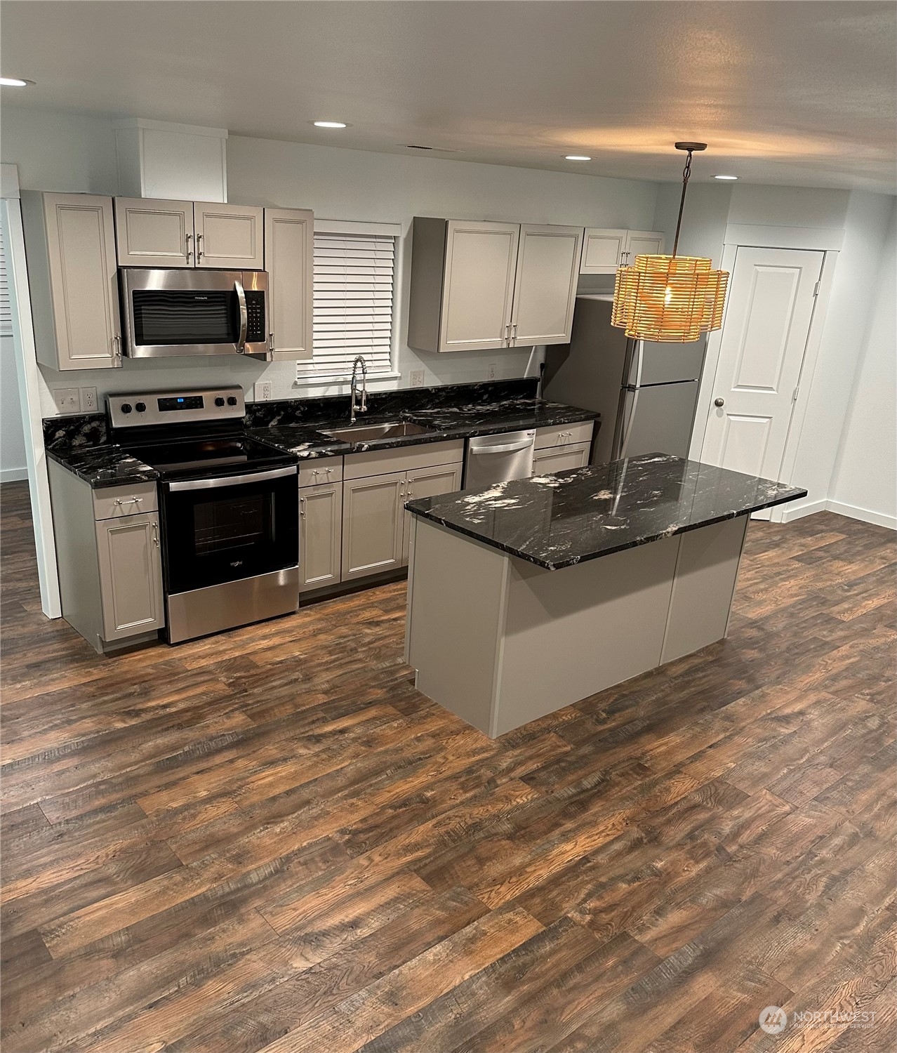 4520 Eels Road Cashmere, WA 98815 - Photo 2 of 17 a kitchen with stainless steel appliances kitchen island granite countertop a stove a sink and a microwave