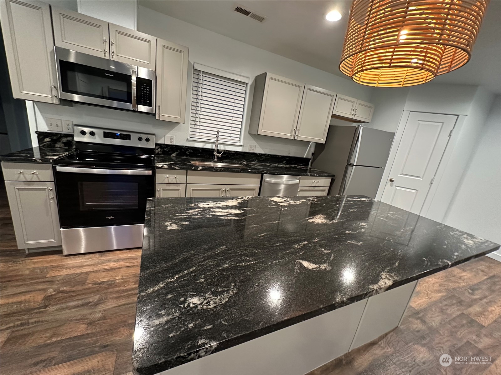 4520 Eels Road Cashmere, WA 98815 - Photo 3 of 17 a kitchen with stainless steel appliances a stove a microwave a sink and cabinets
