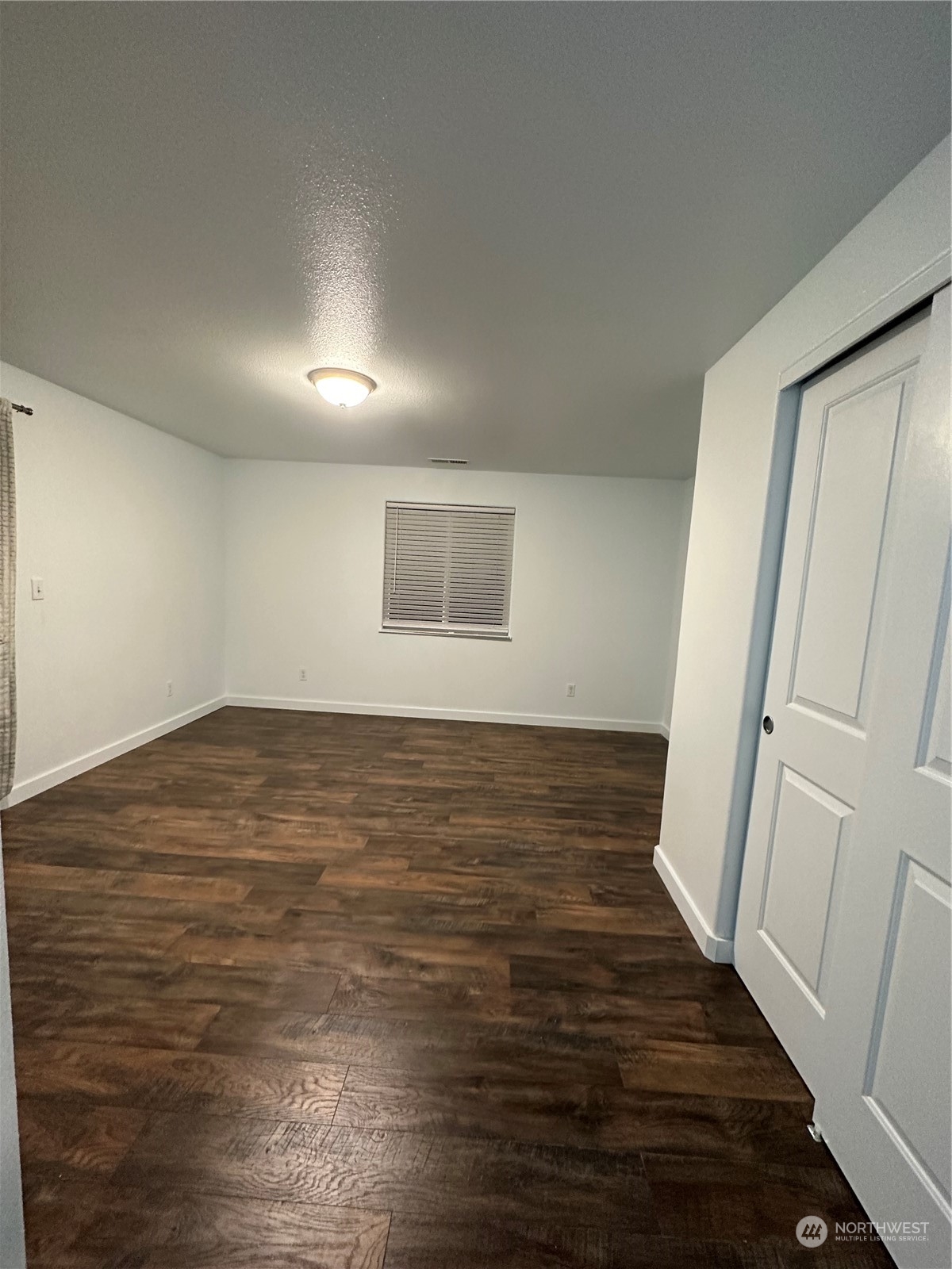 4520 Eels Road Cashmere, WA 98815 - Photo 10 of 17 a view of an empty room with wooden floor and a window