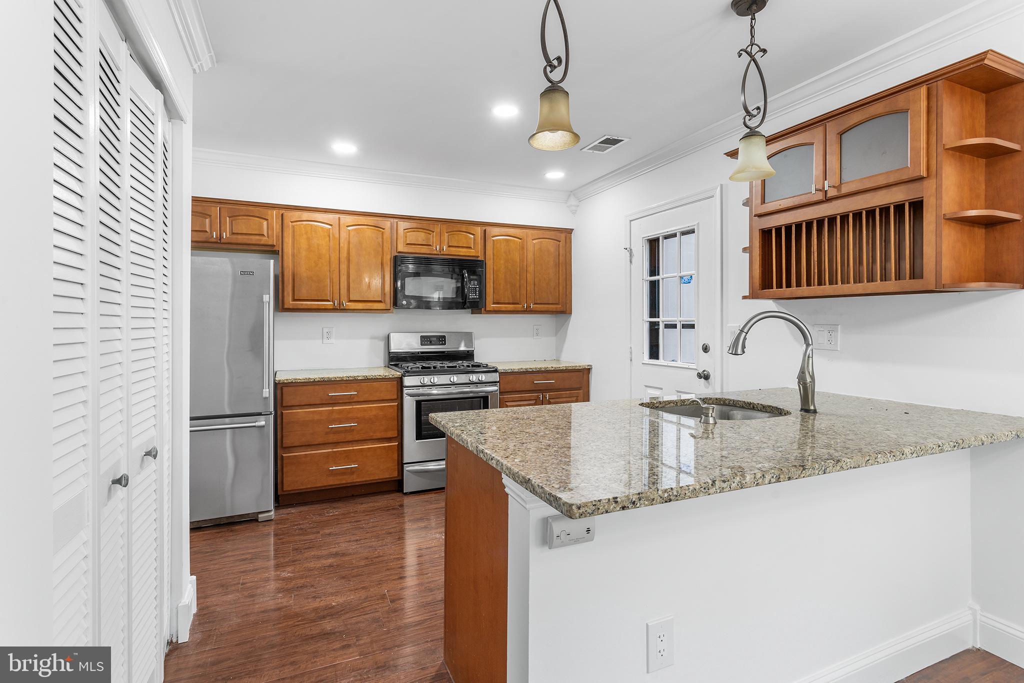 16 Carlyle Court Robbinsville, NJ 08691 - Photo 13 of 30 a kitchen with stainless steel appliances granite countertop a sink stove and refrigerator