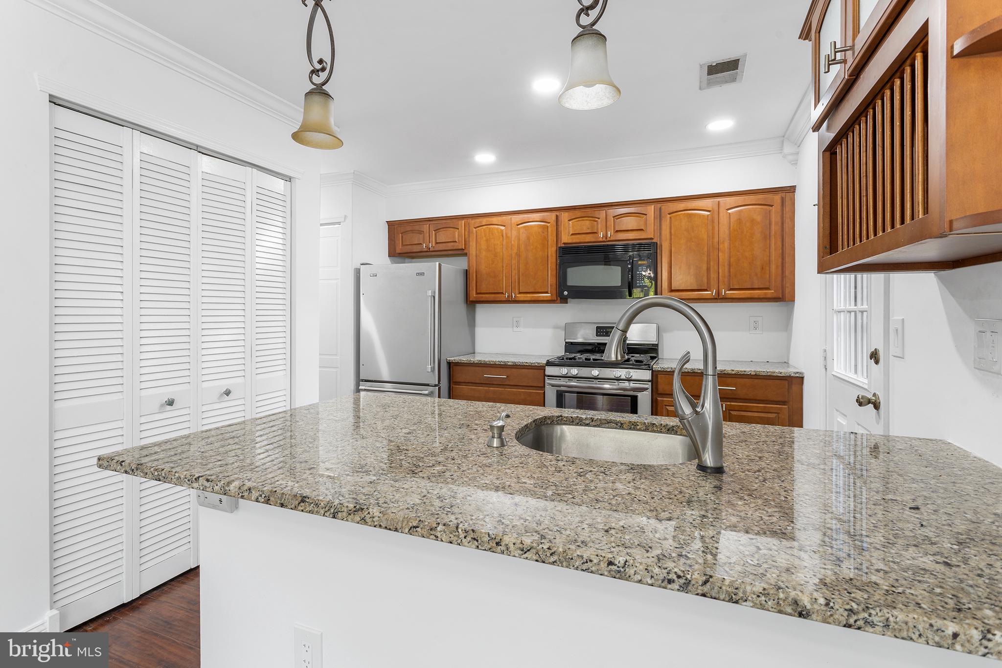 16 Carlyle Court Robbinsville, NJ 08691 - Photo 14 of 30 a kitchen with a sink a counter top space cabinets and stainless steel appliances
