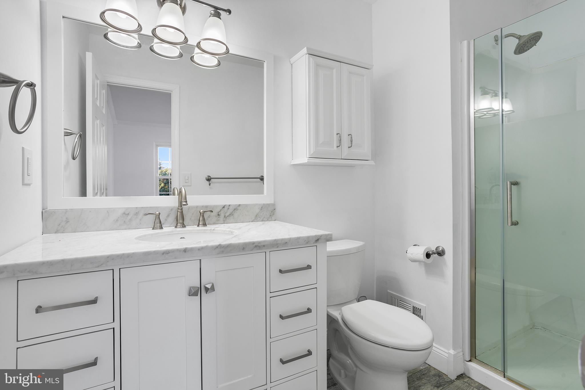 16 Carlyle Court Robbinsville, NJ 08691 - Photo 22 of 30 a bathroom with a granite countertop sink a toilet and a mirror