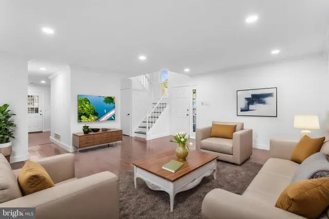 a living room with furniture and a potted plant