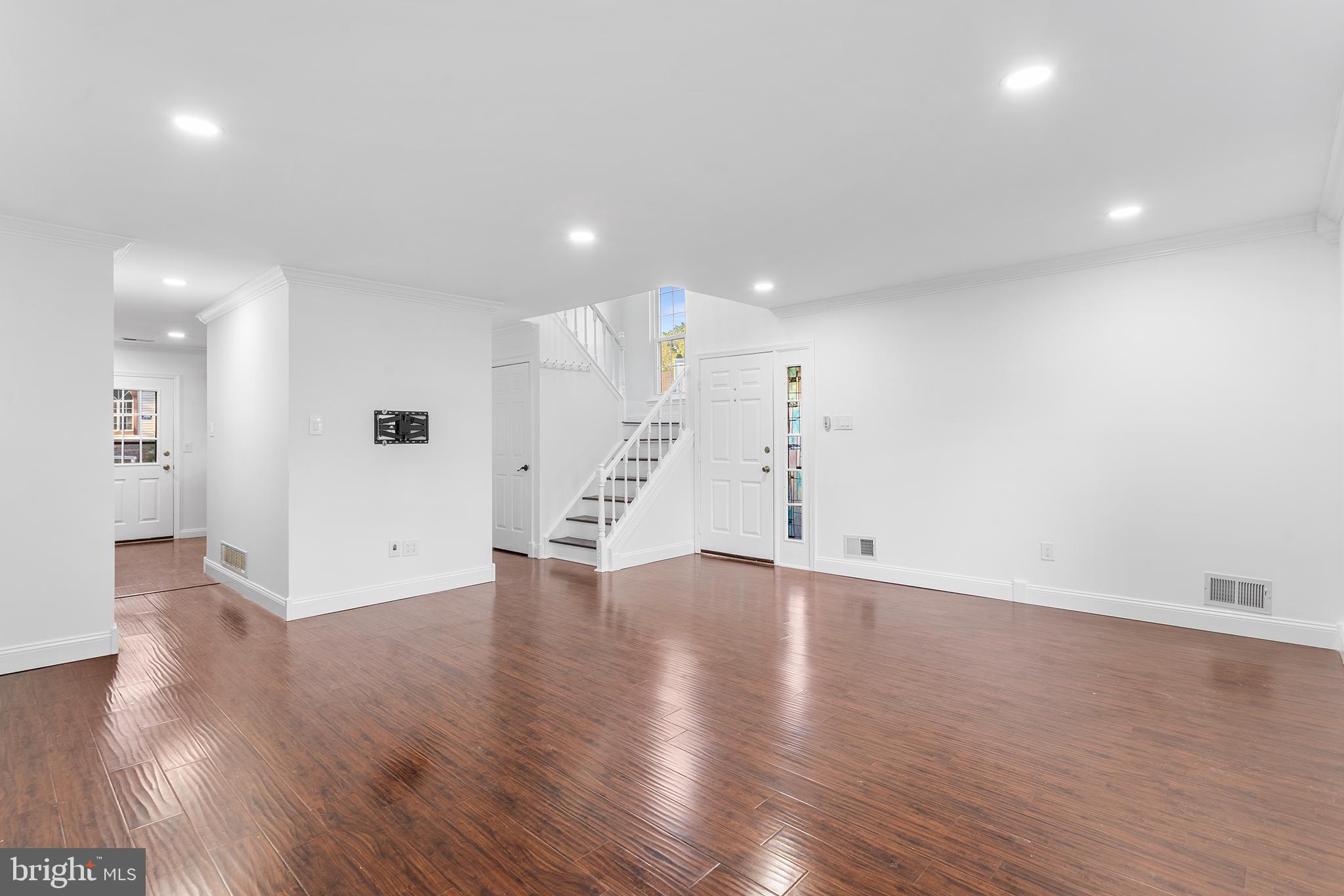 16 Carlyle Court Robbinsville, NJ 08691 - Photo 7 of 30 a view of an empty room with wooden floor and a kitchen