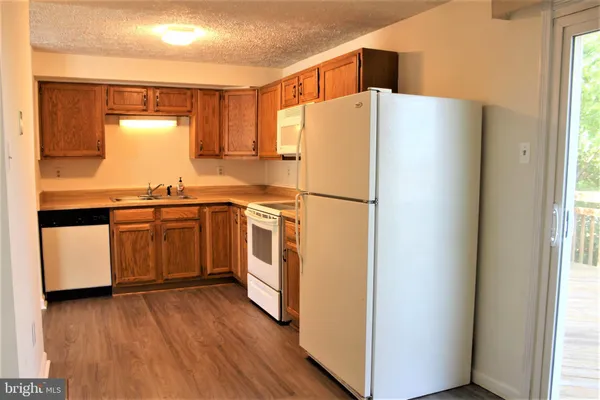 a white refrigerator freezer sitting inside of a kitchen
