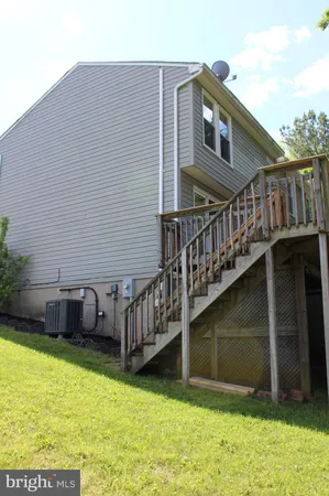 a view of a house with yard and sitting area