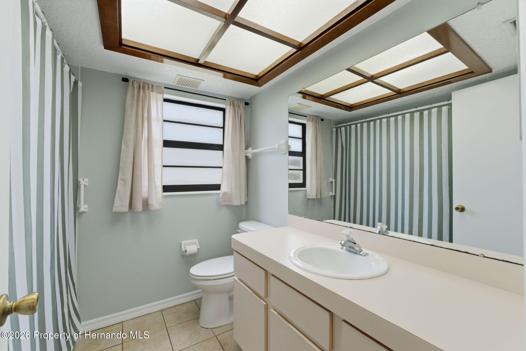 4966 Keysville Avenue Spring Hill, FL 34608 - Photo 35 of 50 a bathroom with a sink toilet and shower
