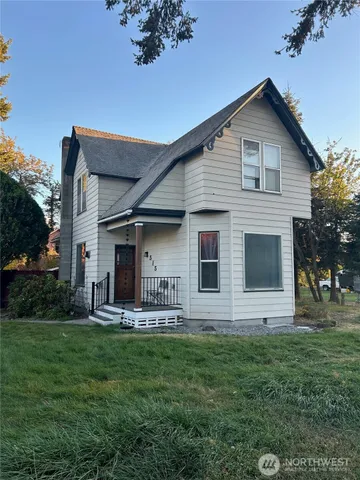 a front view of house with yard and outdoor seating