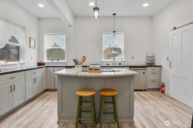 a kitchen with a sink cabinets and wooden floor