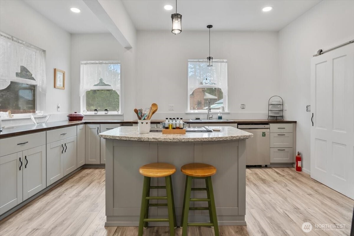 515 North 3rd Street Dayton, WA 99328 - Photo 13 of 31 a kitchen with a sink cabinets and wooden floor