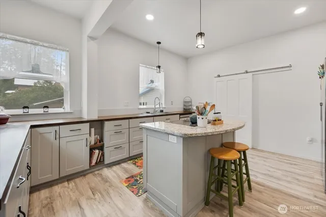 a kitchen with sink cabinets and wooden floor
