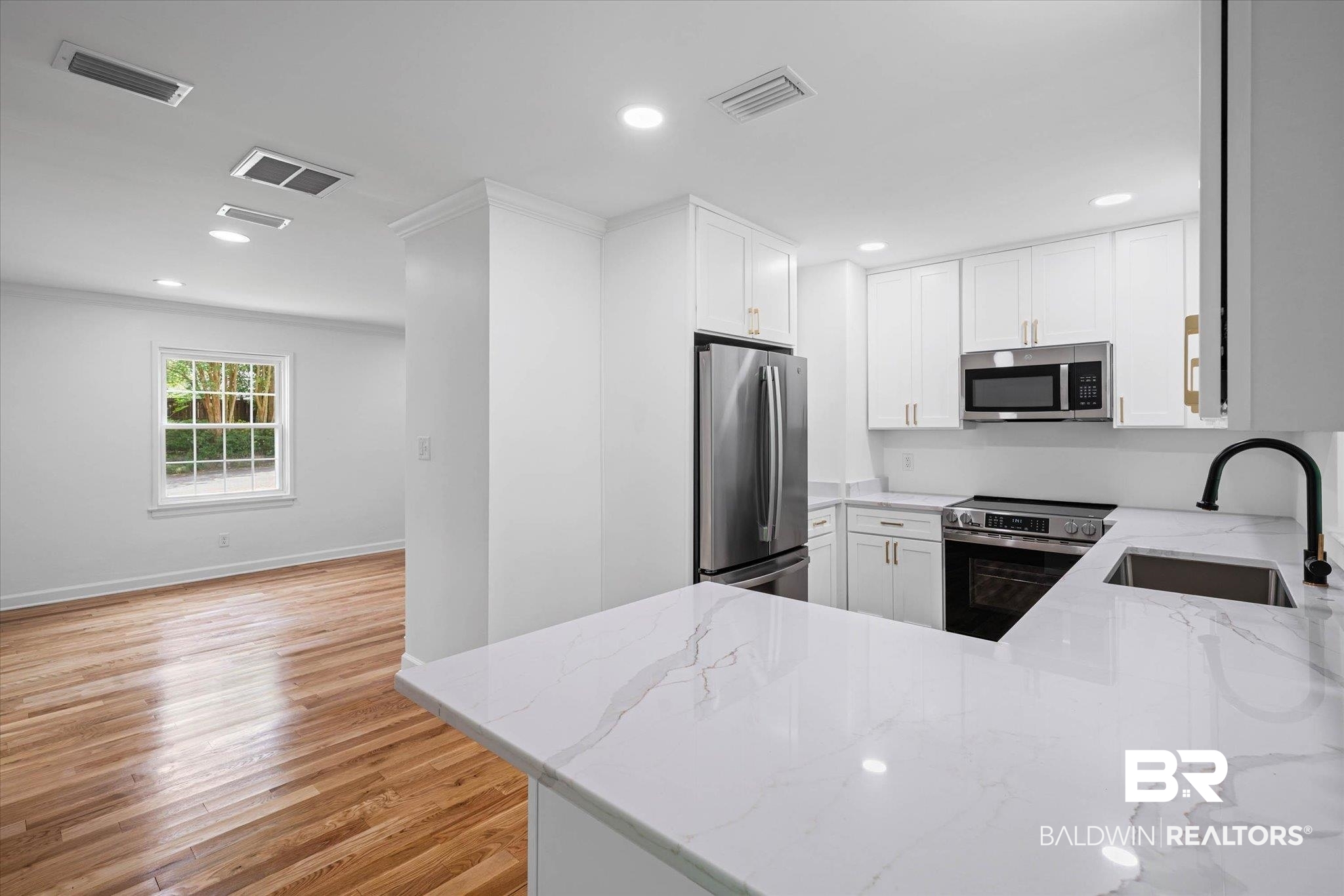 41 Hathaway Road West Mobile, AL 36608 - Photo 7 of 24 Kitchen featuring white cabinetry, stainless steel appliances, light wood-style floors, light stone counters, and recessed lighting