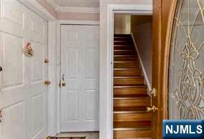 2 James Court, Unit 2 Lodi, NJ 07644 - Photo 2 of 10 a view of a hallway with wooden floor and entryway